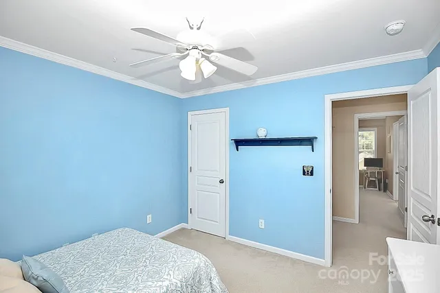 an empty room with fan and entrance
