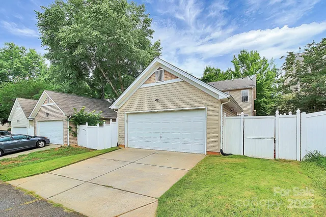 a view of garage yard and front view of a house