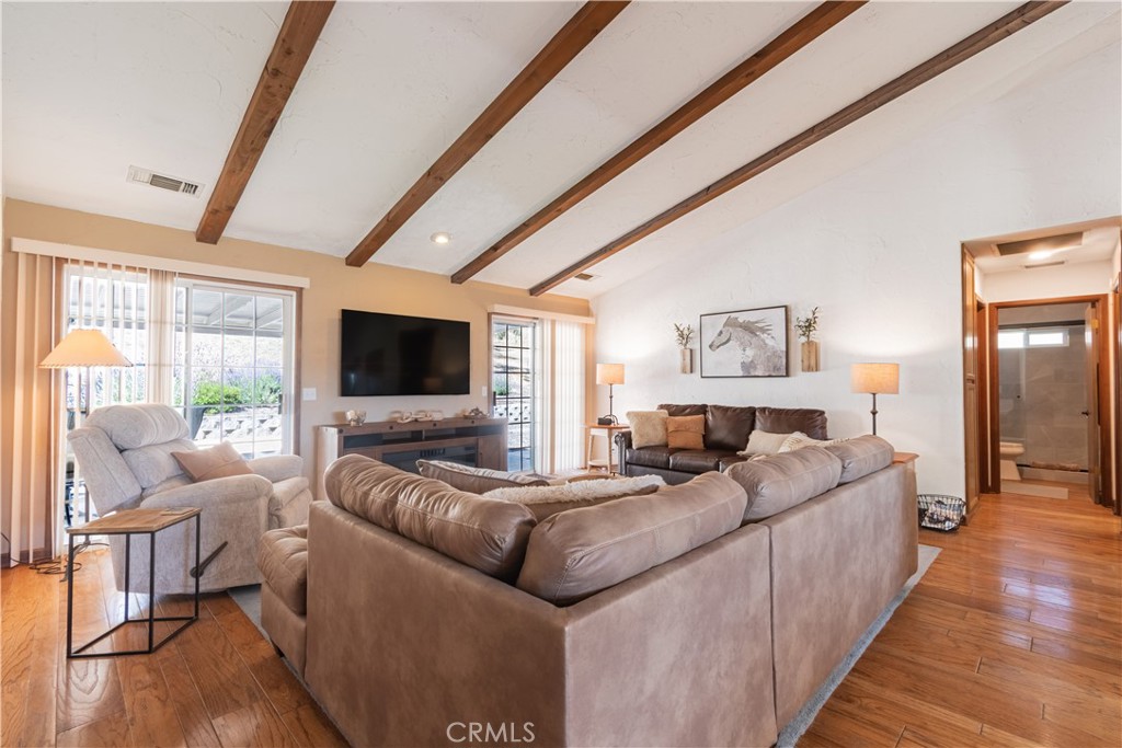 2085 Hanging Tree Lane Templeton, CA 93465 - Photo 9 of 33 Living Room is open and bright with beamed ceilings and wood flooring.