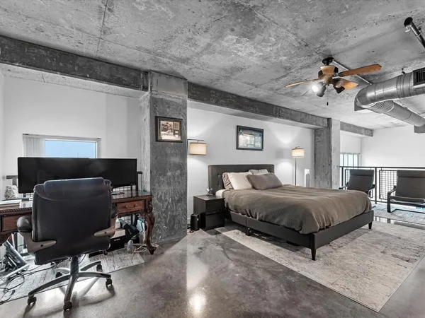 a bedroom with a bed a chair and piano