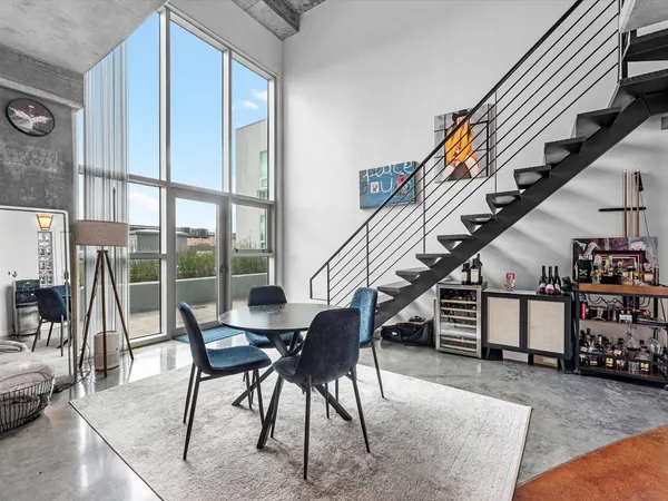 a view of a livingroom with furniture and staircase
