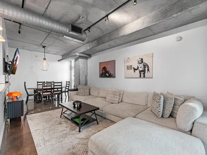 a living room with furniture and a chandelier