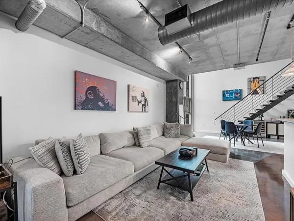 a living room with furniture and wooden floor