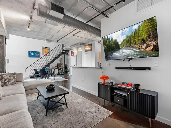 a livingroom with lots of furniture and wooden floor