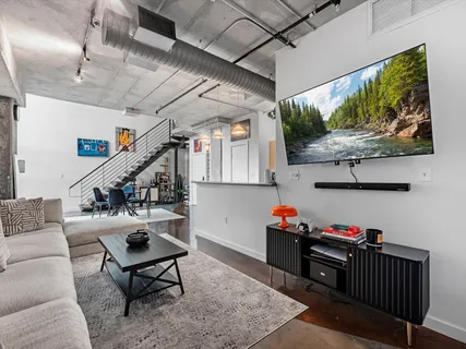 a livingroom with lots of furniture and wooden floor