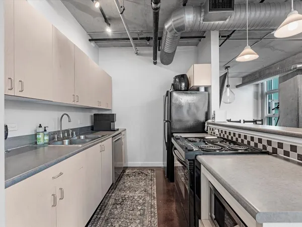 a kitchen with stainless steel appliances granite countertop a stove and a sink