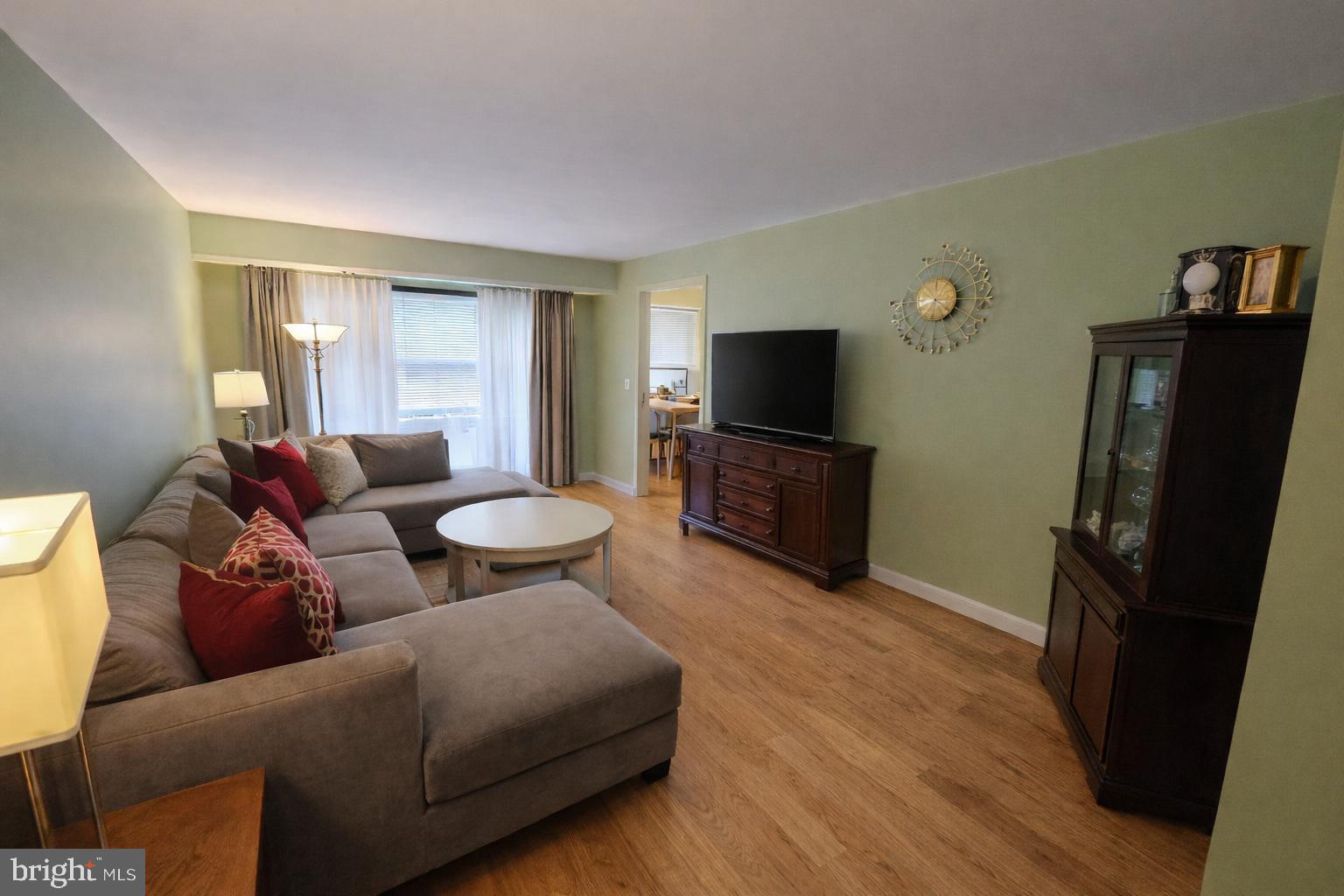 2010 Colts Neck Road, Unit 2B Reston, VA 20191 - Photo 2 of 13 a living room with furniture and a flat screen tv