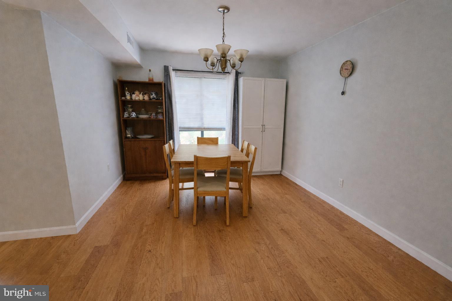 2010 Colts Neck Road, Unit 2B Reston, VA 20191 - Photo 3 of 13 a dining room with furniture a chandelier and wooden floor