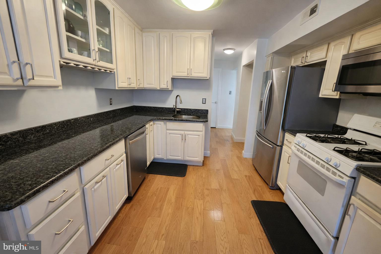2010 Colts Neck Road, Unit 2B Reston, VA 20191 - Photo 4 of 13 a kitchen with stainless steel appliances granite countertop a stove a sink and a refrigerator