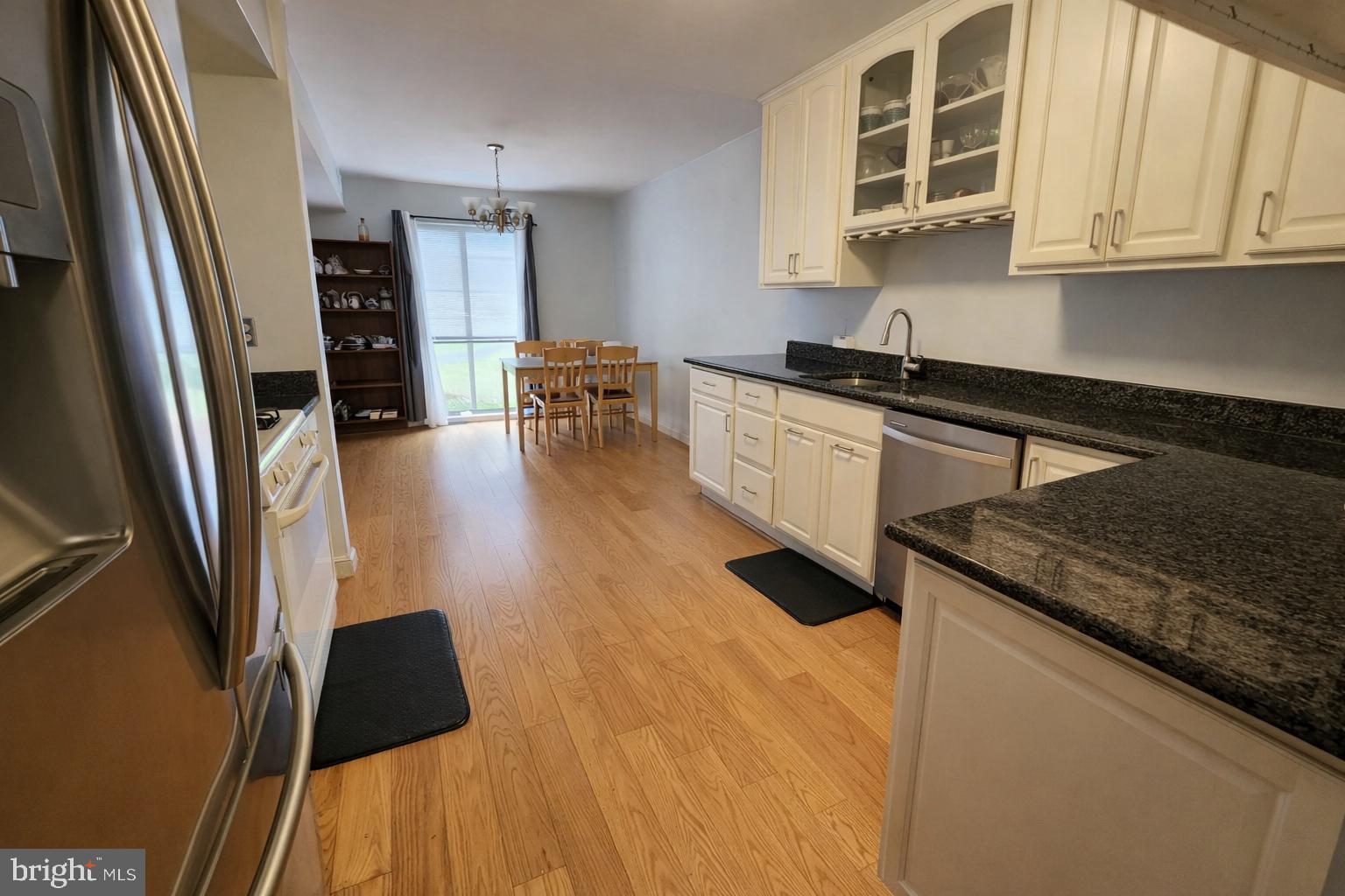 2010 Colts Neck Road, Unit 2B Reston, VA 20191 - Photo 5 of 13 a kitchen with granite countertop a sink a stove and cabinets