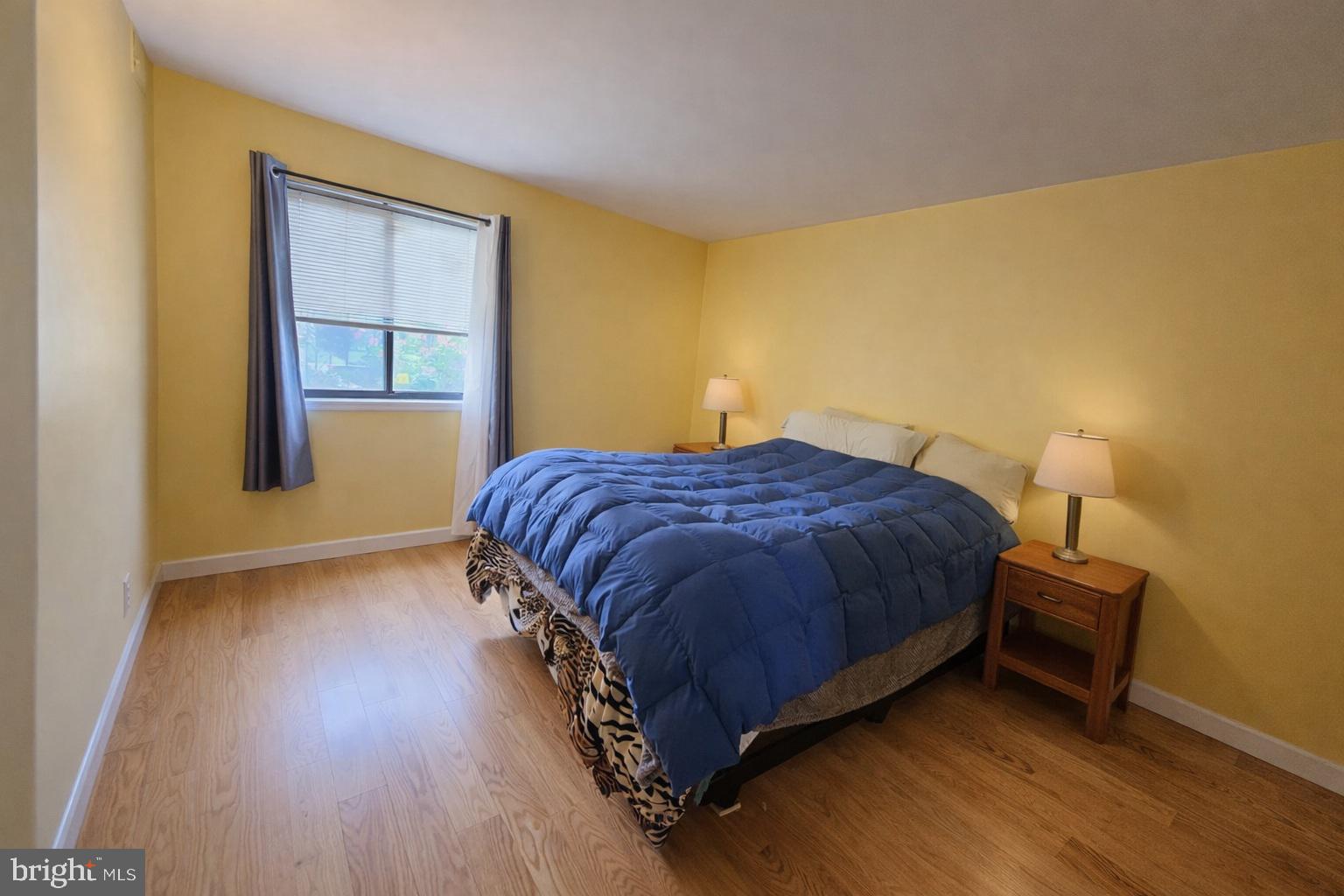 2010 Colts Neck Road, Unit 2B Reston, VA 20191 - Photo 7 of 13 a spacious bedroom with a bed and a table in it