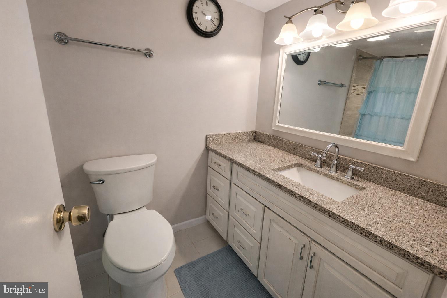 2010 Colts Neck Road, Unit 2B Reston, VA 20191 - Photo 8 of 13 a bathroom with a granite countertop toilet sink and mirror