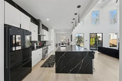 a living room with furniture and kitchen view