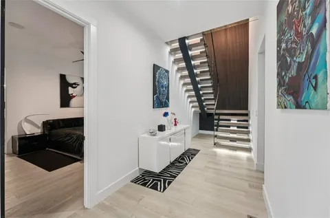 a bedroom with a bed and a painting on the wall