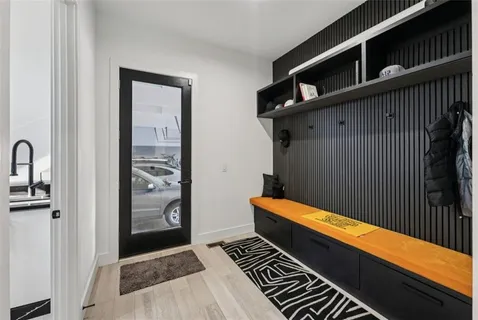 a large white kitchen with stainless steel appliances a refrigerator and cabinets