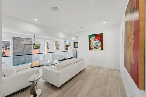 a large white kitchen with lots of counter space and glass door