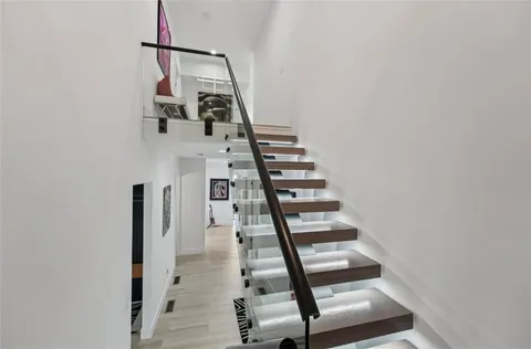 a living room with furniture and a floor to ceiling window