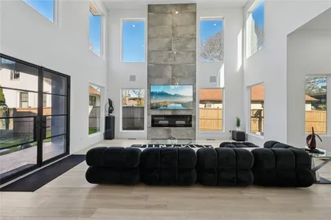 a living room with furniture a table and large window