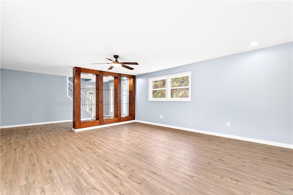 93 Old 51 Road Perryopolis, PA 15473 - Photo 16 of 44 a view of an empty room with wooden floor and a window