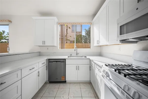 a kitchen with a stove a sink and a refrigerator