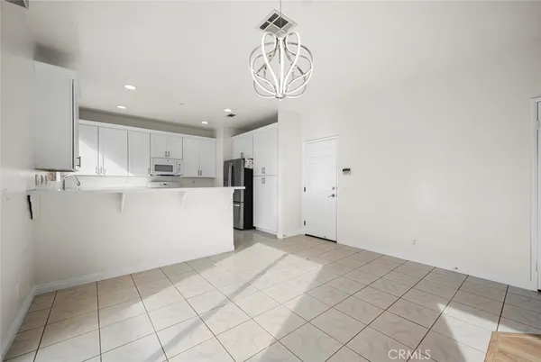 a view of an empty room with a fireplace and a window