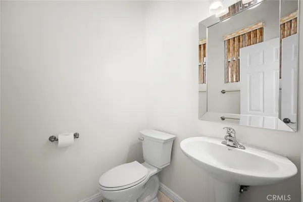 a white toilet sitting next to a shower