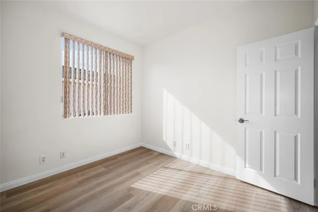 a view of a room with wooden floor