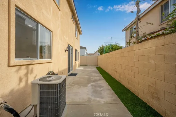a view of a brick house with a bench