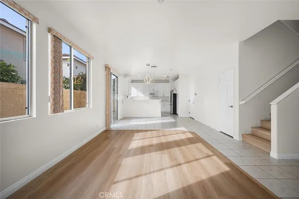 a kitchen with stainless steel appliances kitchen island granite countertop a refrigerator and a stove top oven