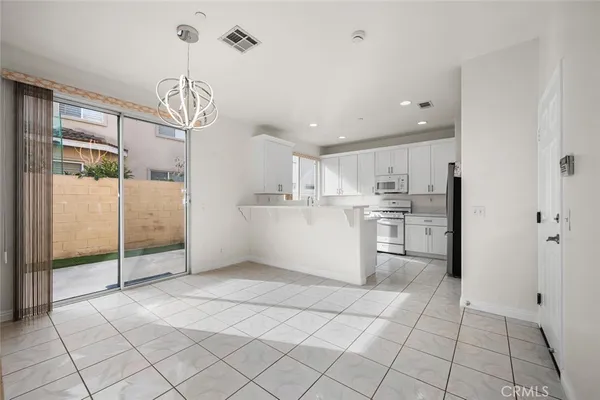 a kitchen with a sink stove top oven and cabinets