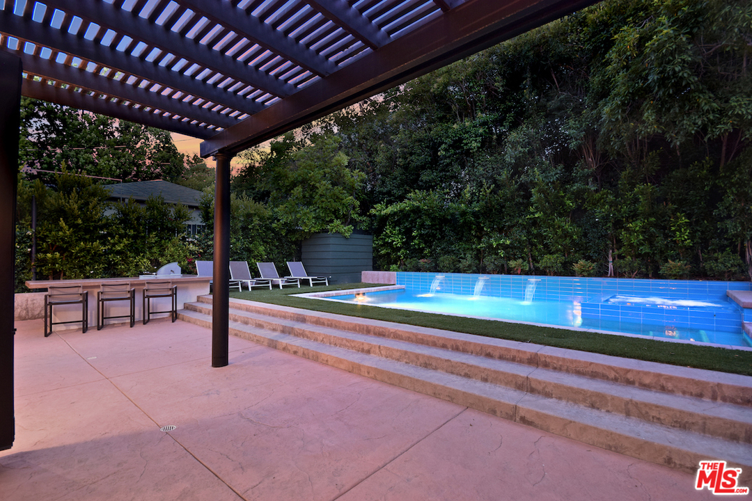 14520 Greenleaf Street Sherman Oaks, CA 91403 - Photo 21 of 54 a view of a swimming pool with a bench in patio