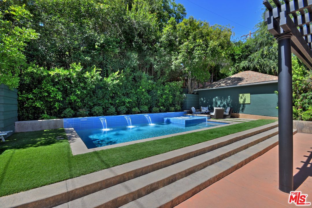 14520 Greenleaf Street Sherman Oaks, CA 91403 - Photo 25 of 54 a view of swimming pool with lawn chairs under an umbrella