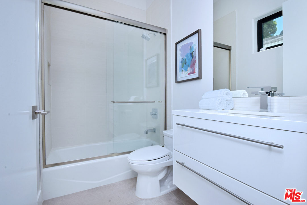 14520 Greenleaf Street Sherman Oaks, CA 91403 - Photo 38 of 54 a bathroom with a white toilet sitting next to a bathroom sink
