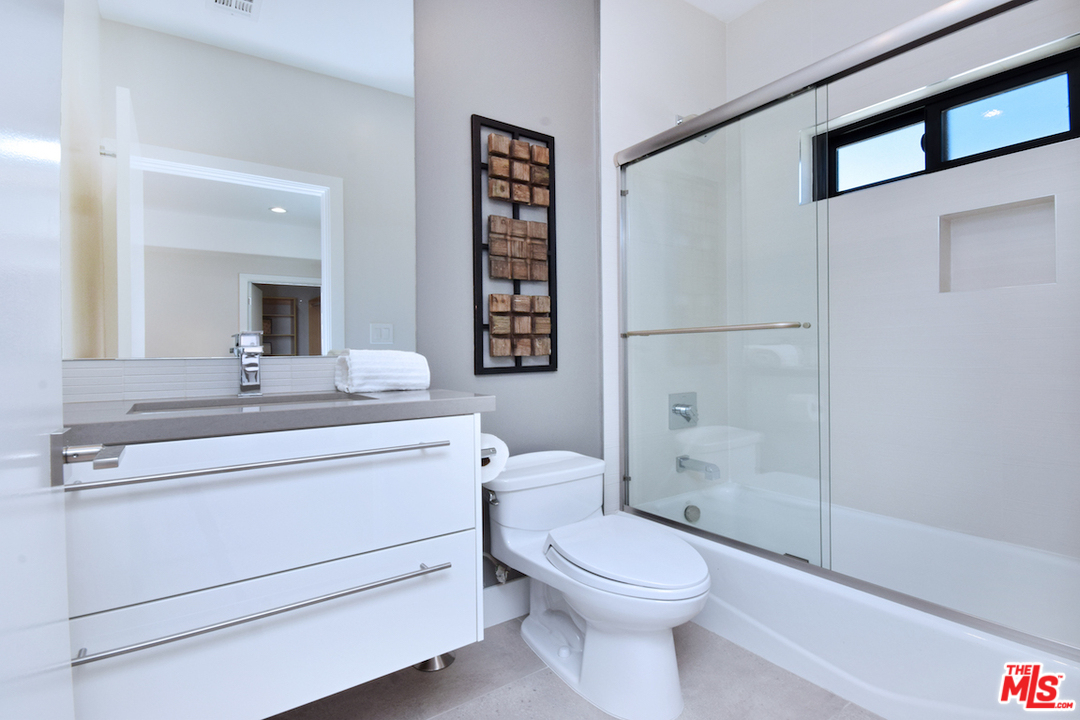 14520 Greenleaf Street Sherman Oaks, CA 91403 - Photo 44 of 54 a bathroom with a toilet a sink and a mirror