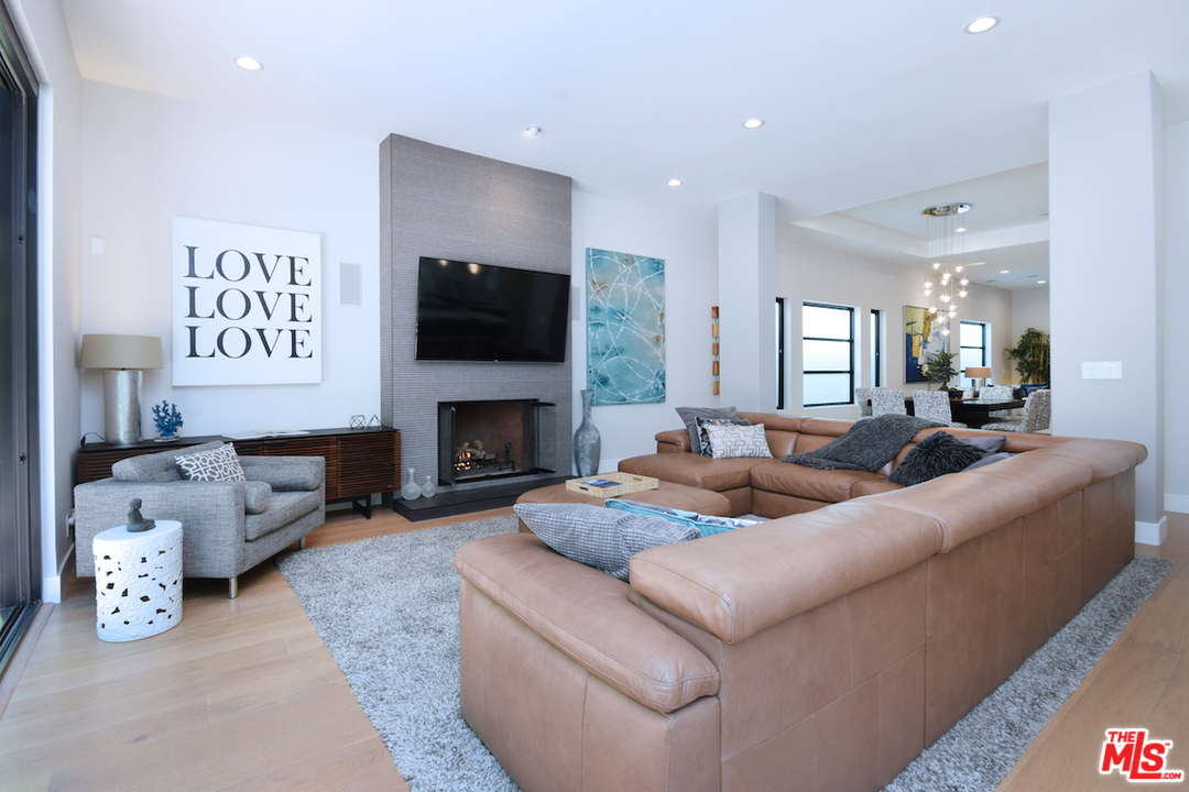 14520 Greenleaf Street Sherman Oaks, CA 91403 - Photo 7 of 54 a living room with furniture a flat screen tv and a fireplace