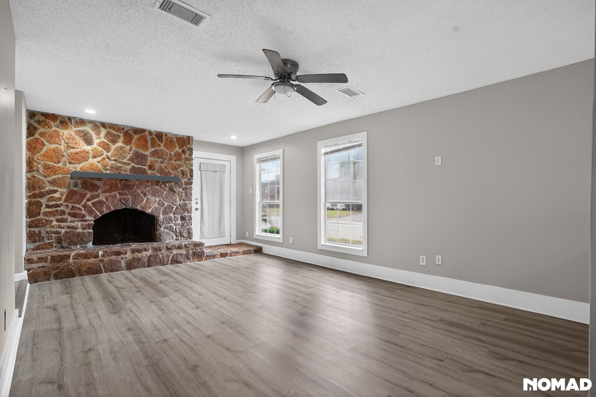 17805 Villa Way Drive Spring, TX 77379 - Photo 11 of 38 a view of empty room with wooden floor and fireplace