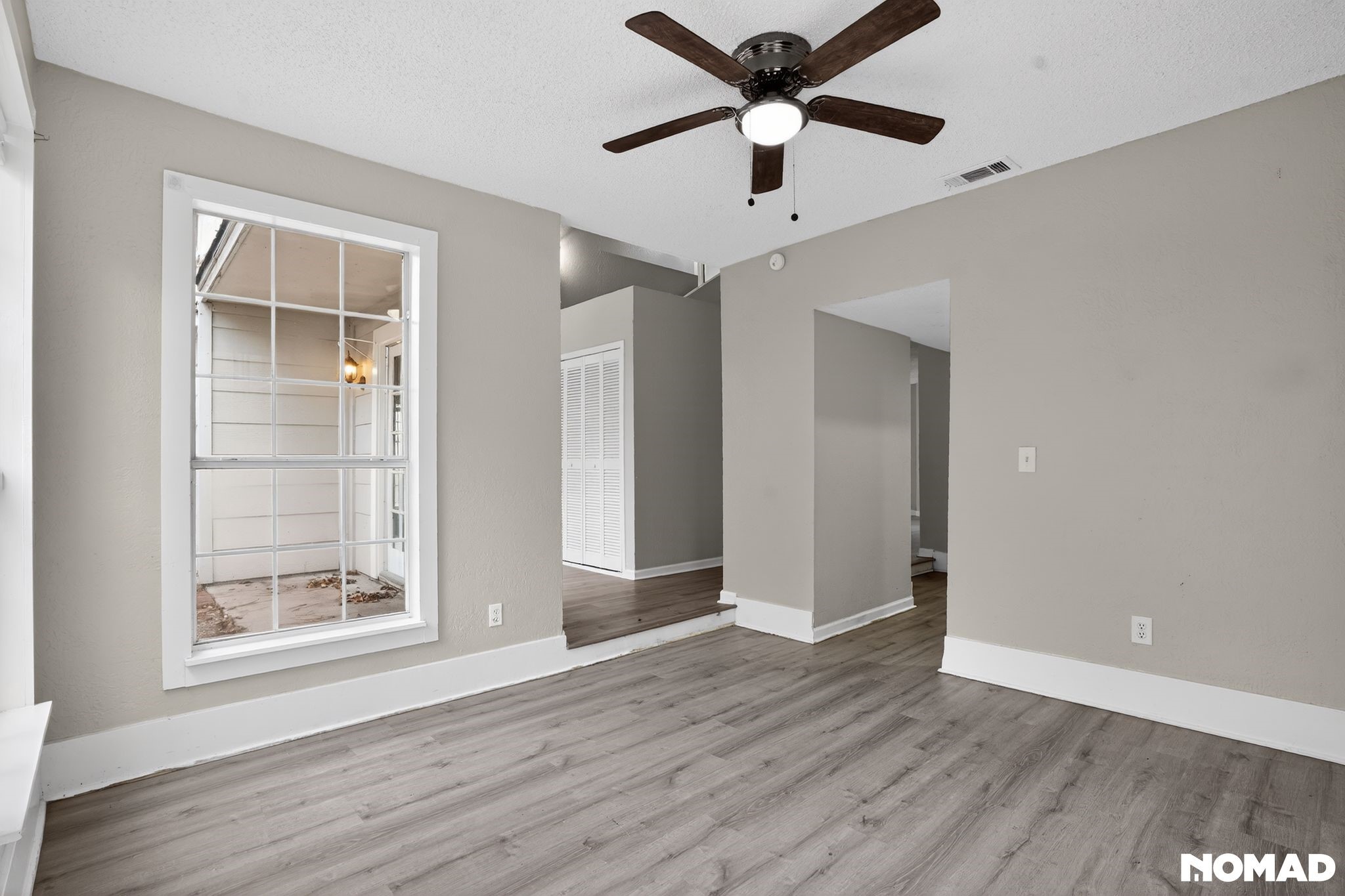 17805 Villa Way Drive Spring, TX 77379 - Photo 19 of 38 an empty room with wooden floor and windows