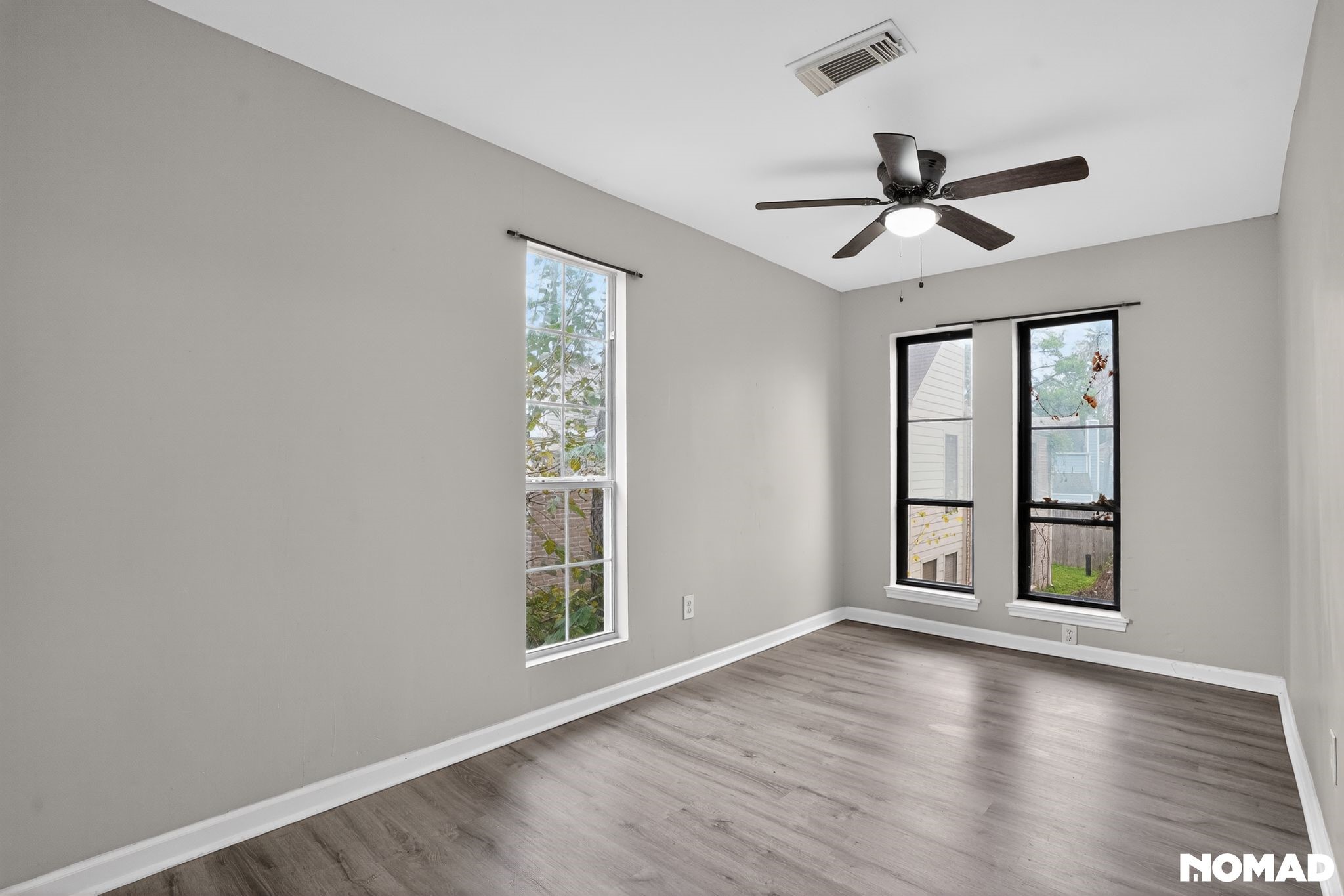 17805 Villa Way Drive Spring, TX 77379 - Photo 26 of 38 an empty room with wooden floor fan and windows