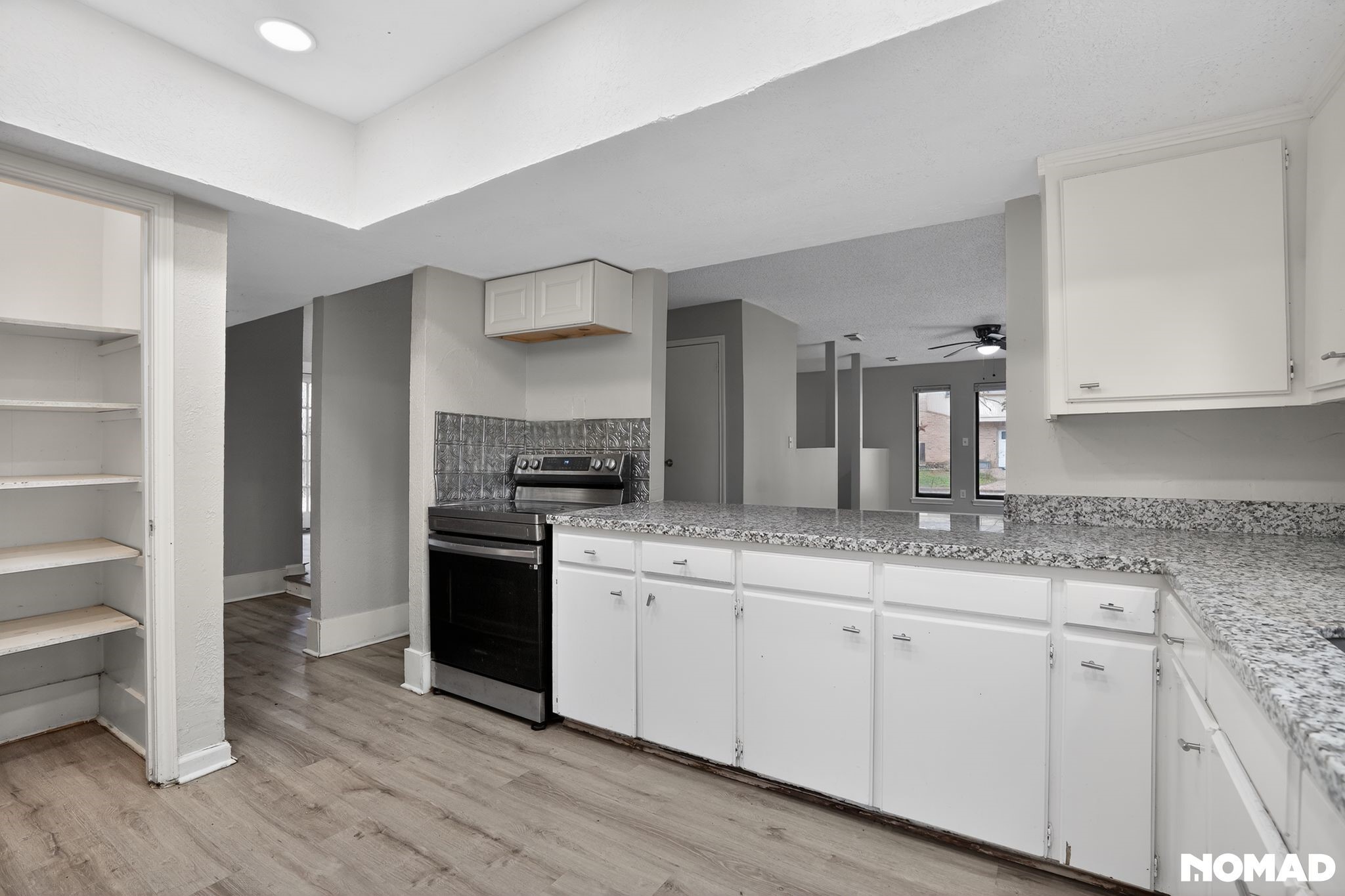 17805 Villa Way Drive Spring, TX 77379 - Photo 6 of 38 a kitchen with granite countertop white cabinets and stainless steel appliances