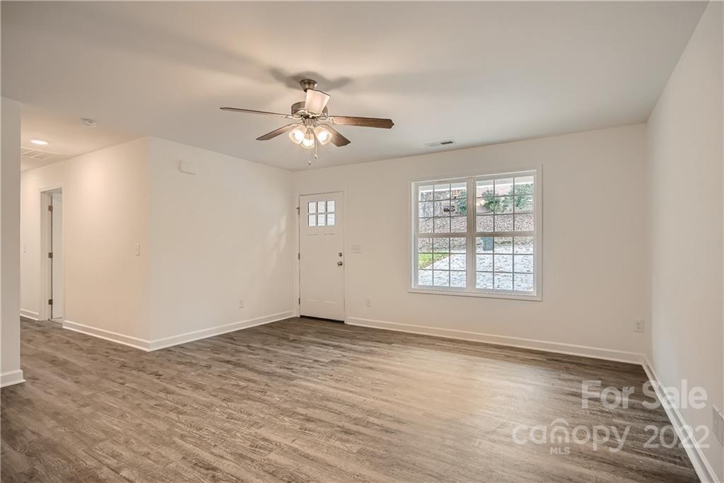 1901 Collins Drive Albemarle, NC 28001 - Photo 2 of 11 wooden floor in an empty room with a window
