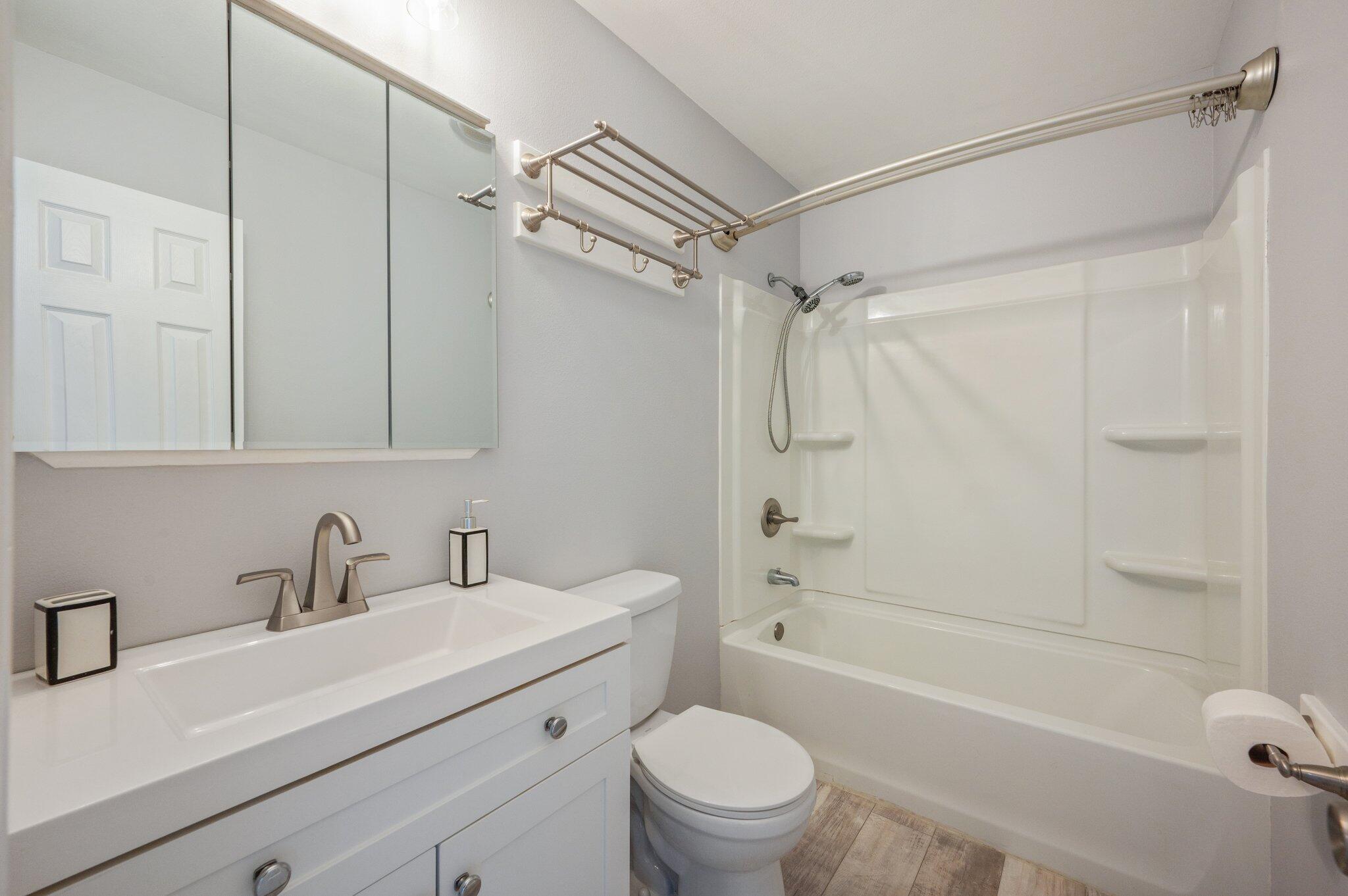 710 Legion Drive Destin, FL 32541 - Photo 22 of 29 a bathroom with a sink toilet a shower and a mirror