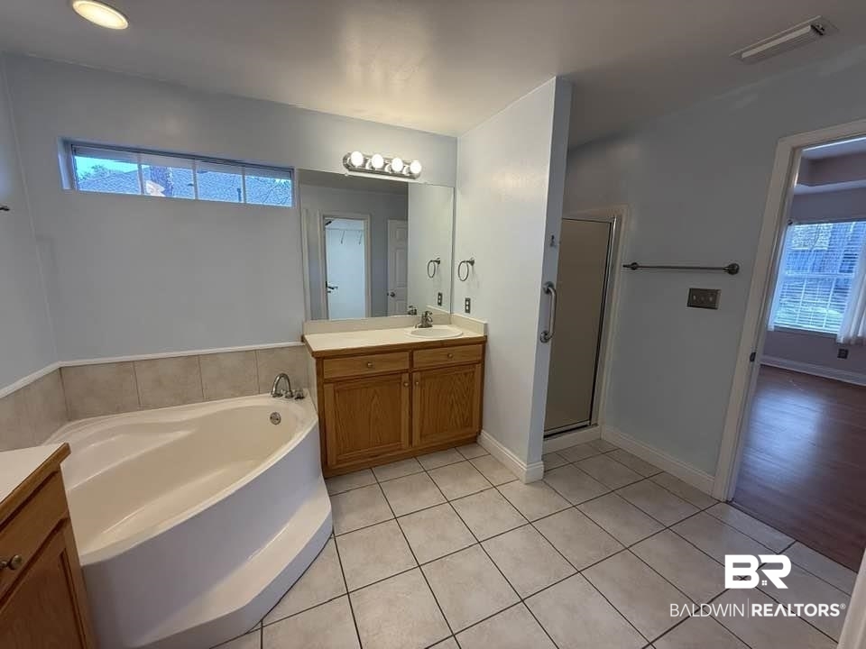 10428 South Side Loop Fairhope, AL 36532 - Photo 22 of 28 Full bath featuring visible vents, a stall shower, vanity, a bath, and tile patterned floors