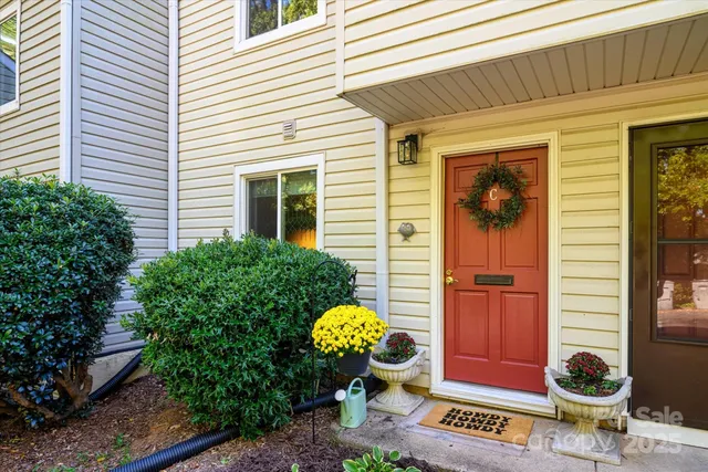 a bathroom with a toilet and a potted plant