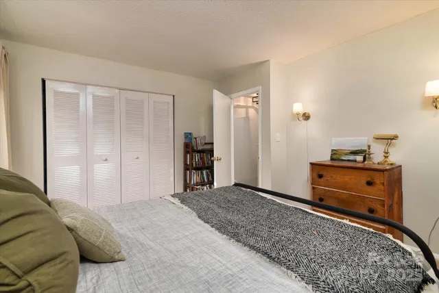 a bedroom with a bed and cabinets