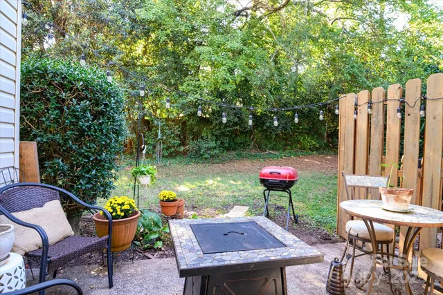 a view of a chairs and table in a backyard