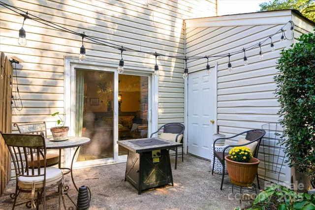 a backyard of a house with barbeque oven table and chairs