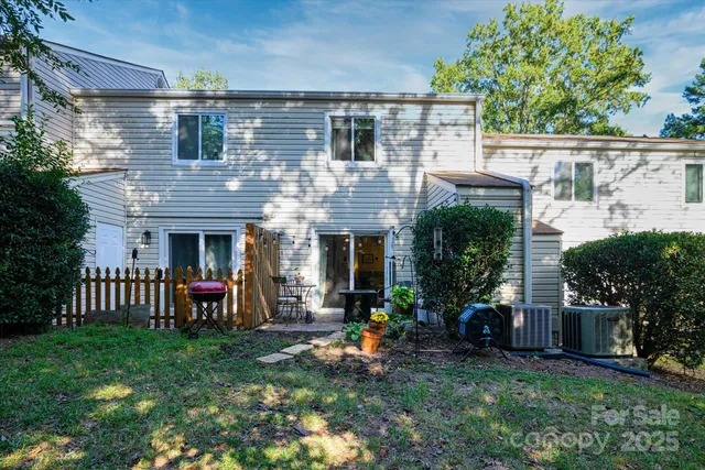 a view of a house with a yard and furniture