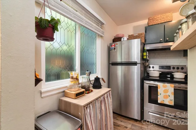 a kitchen with a refrigerator and a stove