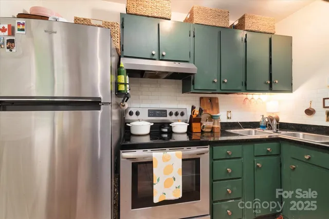 a kitchen with stainless steel appliances granite countertop a refrigerator and a sink