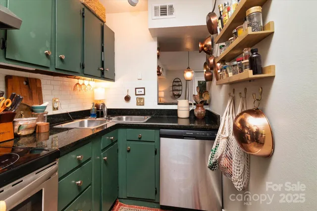 a kitchen with stainless steel appliances granite countertop a sink and cabinets